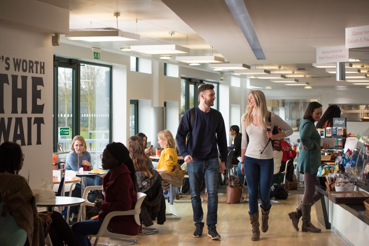 Postgraduate students walking through Cafe Aspire, Jubilee Campus