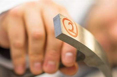 Close-up photograph of person holding metal equipment