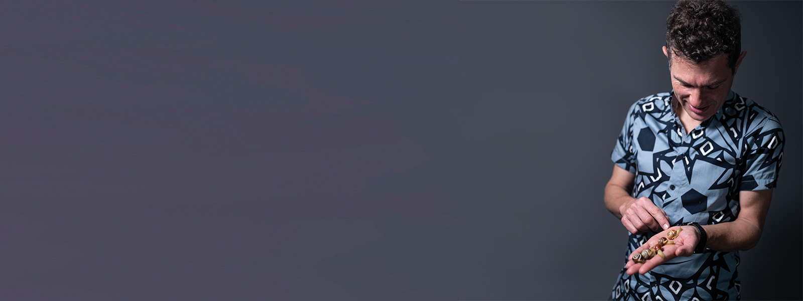 Dr Angus Davison holding snails