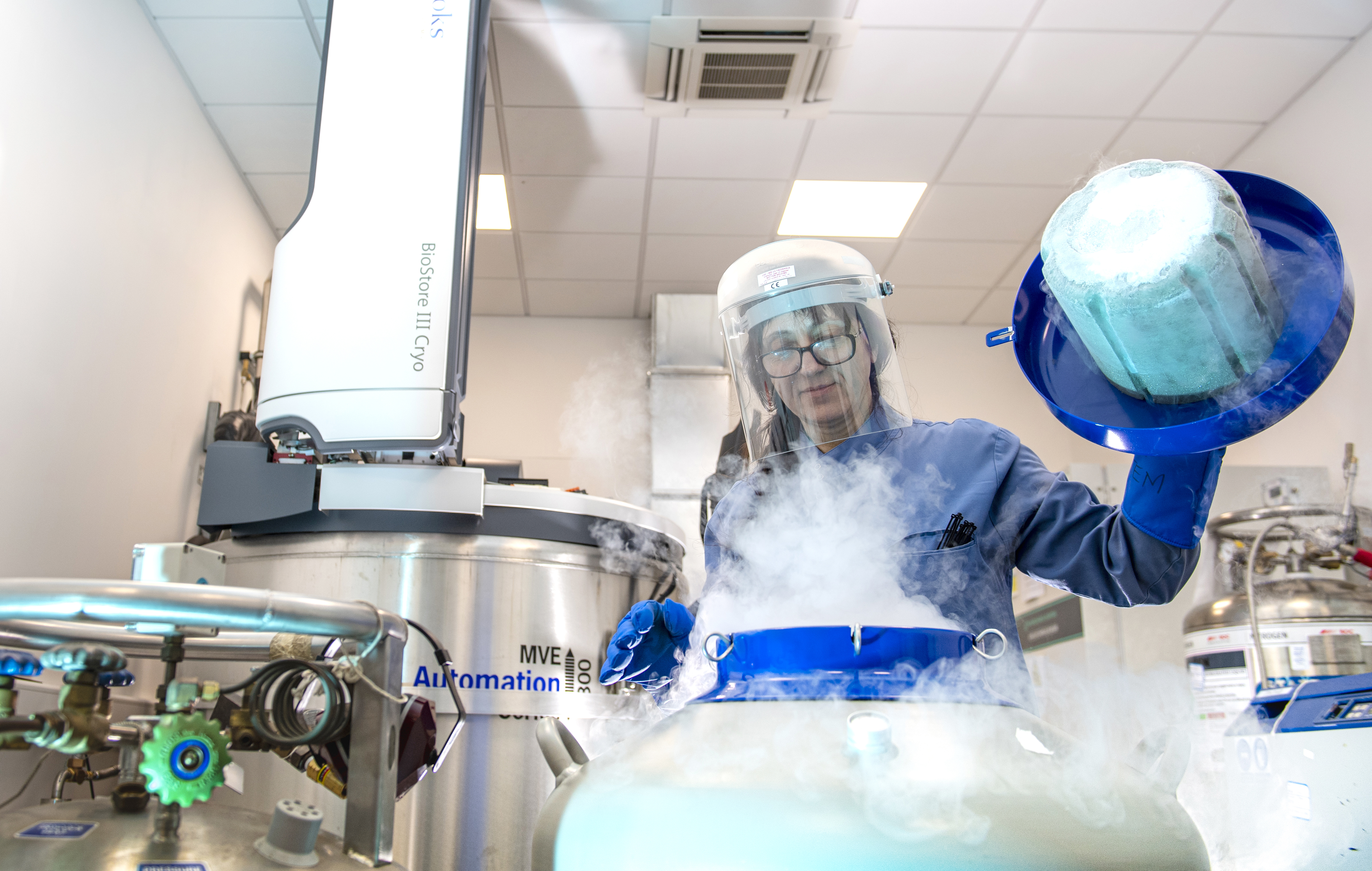 A scientist opening a liquid nitrogen container