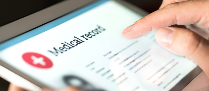 Person using a tablet to fill out a medical record form