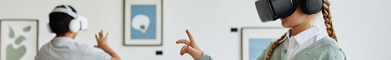 Students exploring a gallary with virtual reality headsets.