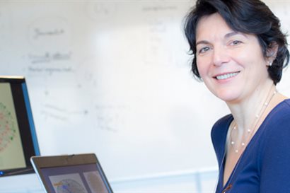 Smiling woman using specialised computer technology