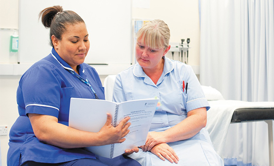 Students discussing course text at QMC