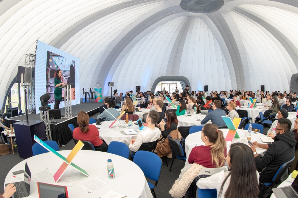 An image of a speaker on stage on an events day