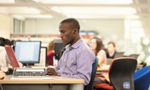 Male staff memeber working at desk