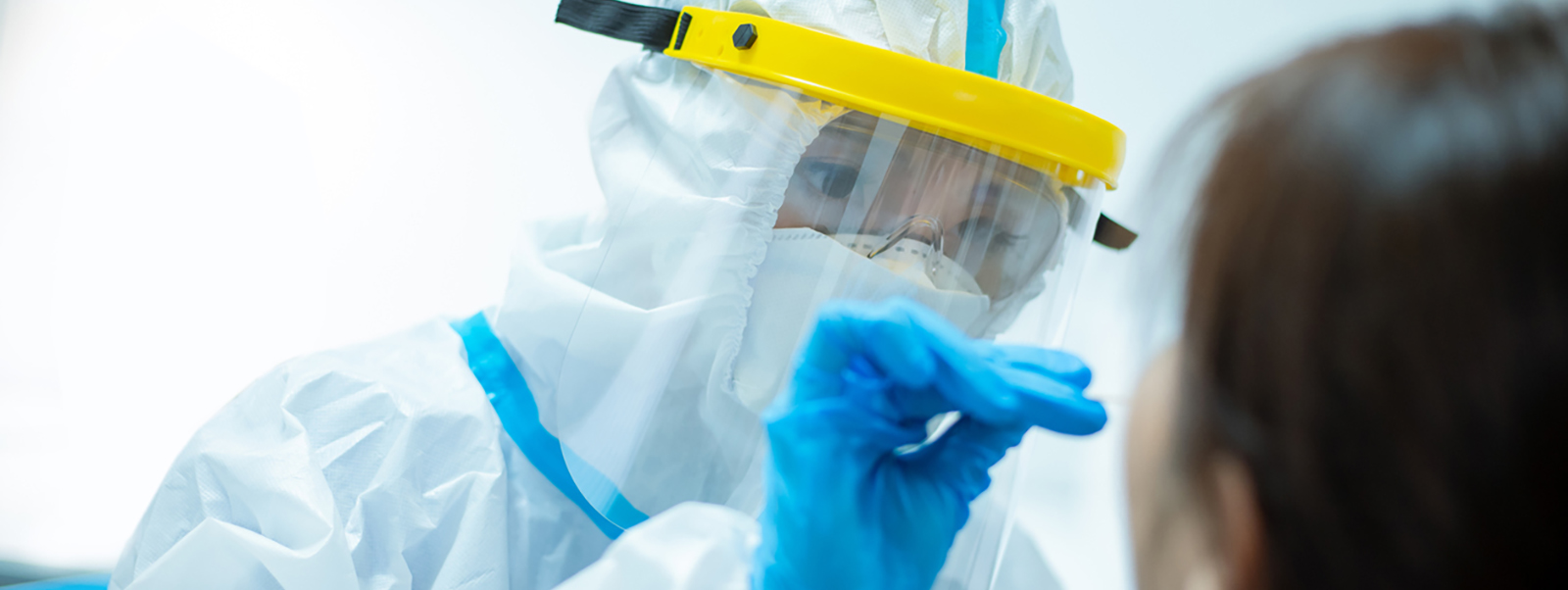 Health worker doing a Covid test wearing PPE