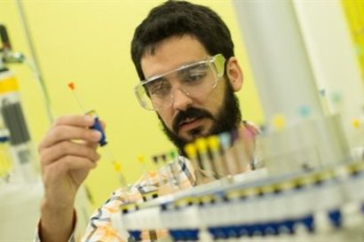 Begoggled man operating specialist machinery