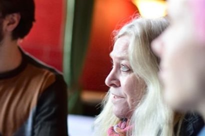 Close-up photograph of three people in conversation
