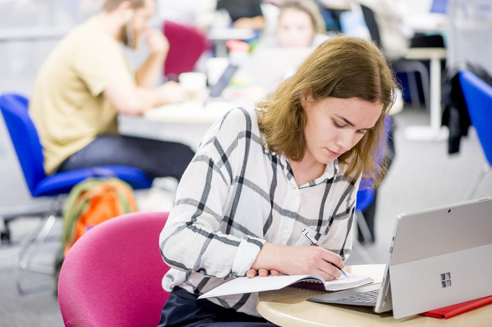 Student writing in a notebook