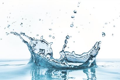 Close-up photograph of water droplet splashing into water