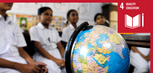 Globe in a classroom with students in the background