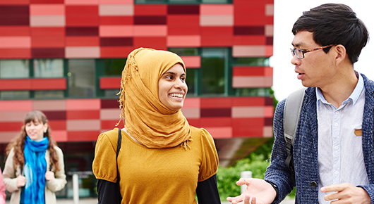 Two students talking and smiling on Jubilee campus