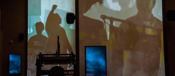 Silhouette of people projected onto digital screen