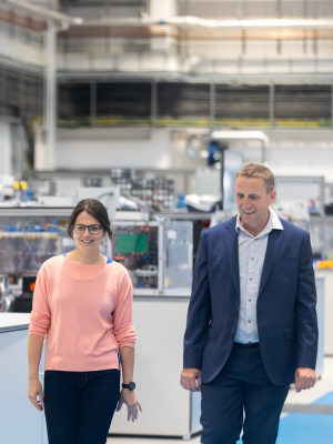 Two people standing in a factory setting