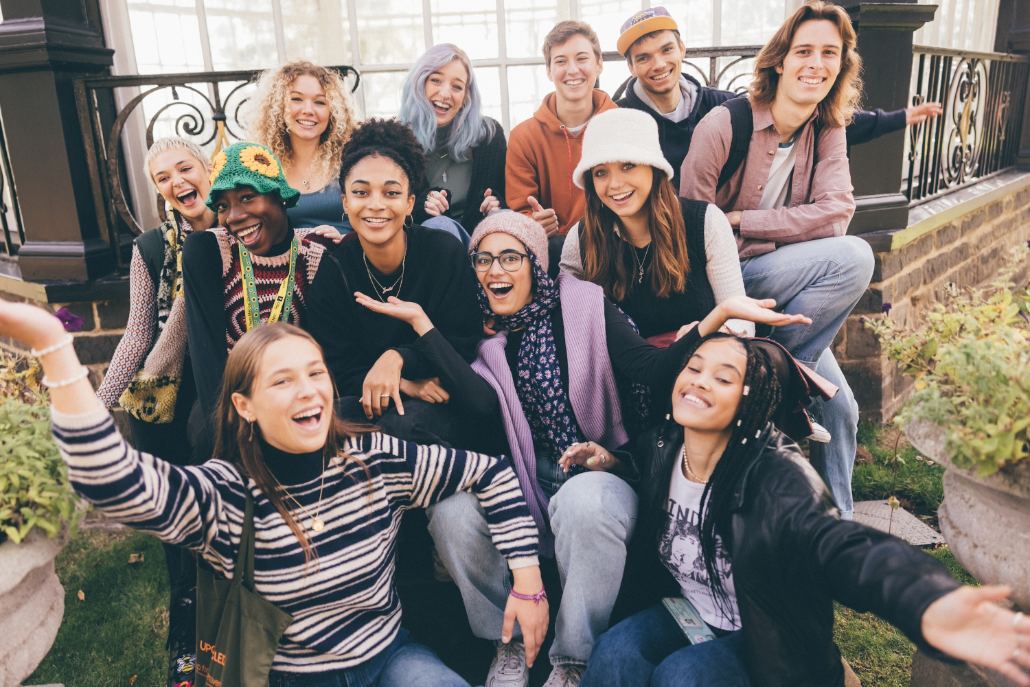 Mixed group of students smiling and laughing at the camera