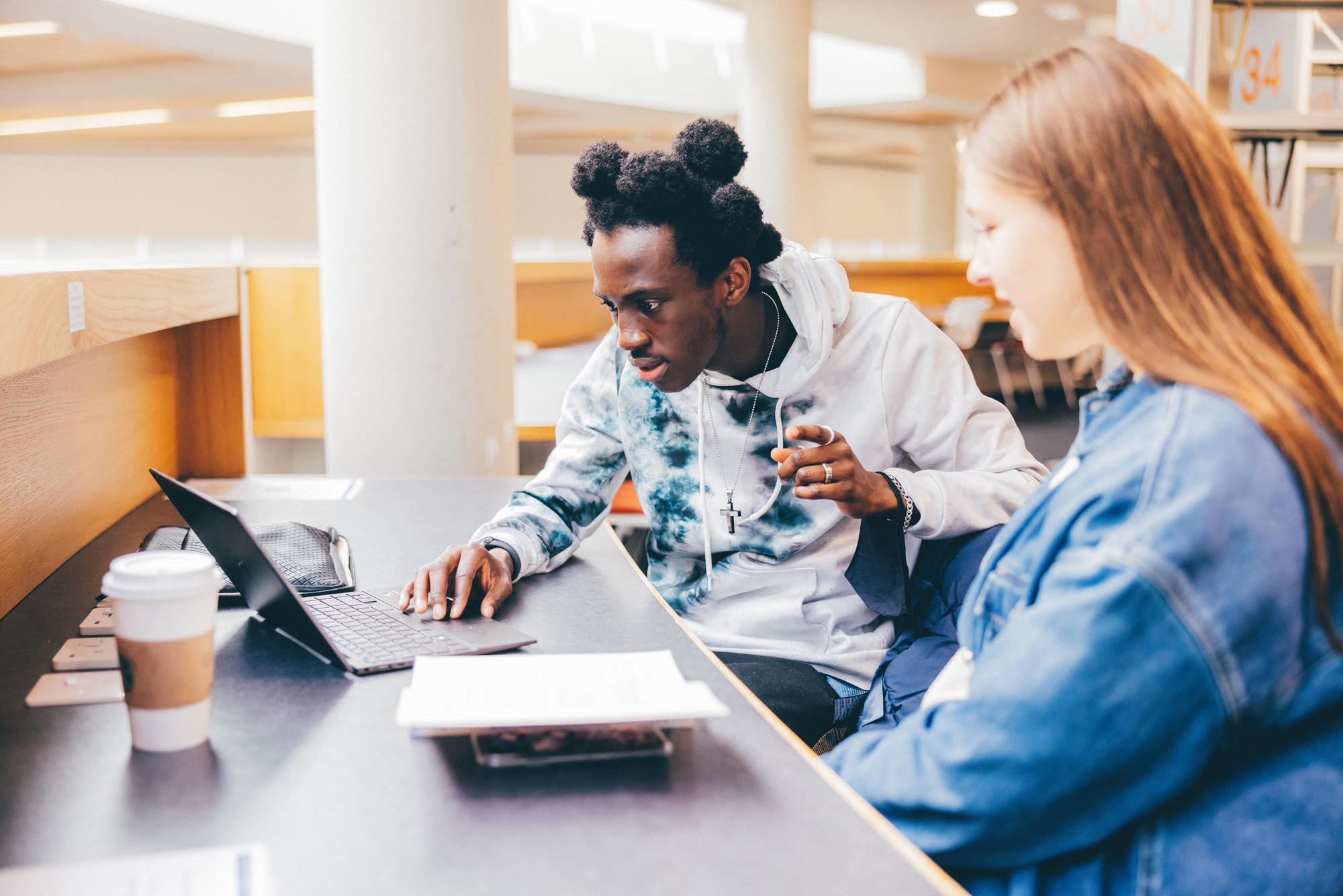 Two students studying in the library